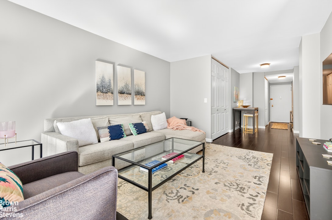 520 East 72nd Street, Unit 5F Manhattan, NY 10021 - Photo 2 of 16 a living room with furniture and a table