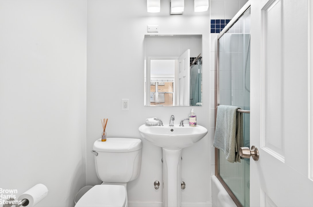 520 East 72nd Street, Unit 5F Manhattan, NY 10021 - Photo 8 of 16 a bathroom with a toilet sink and mirror