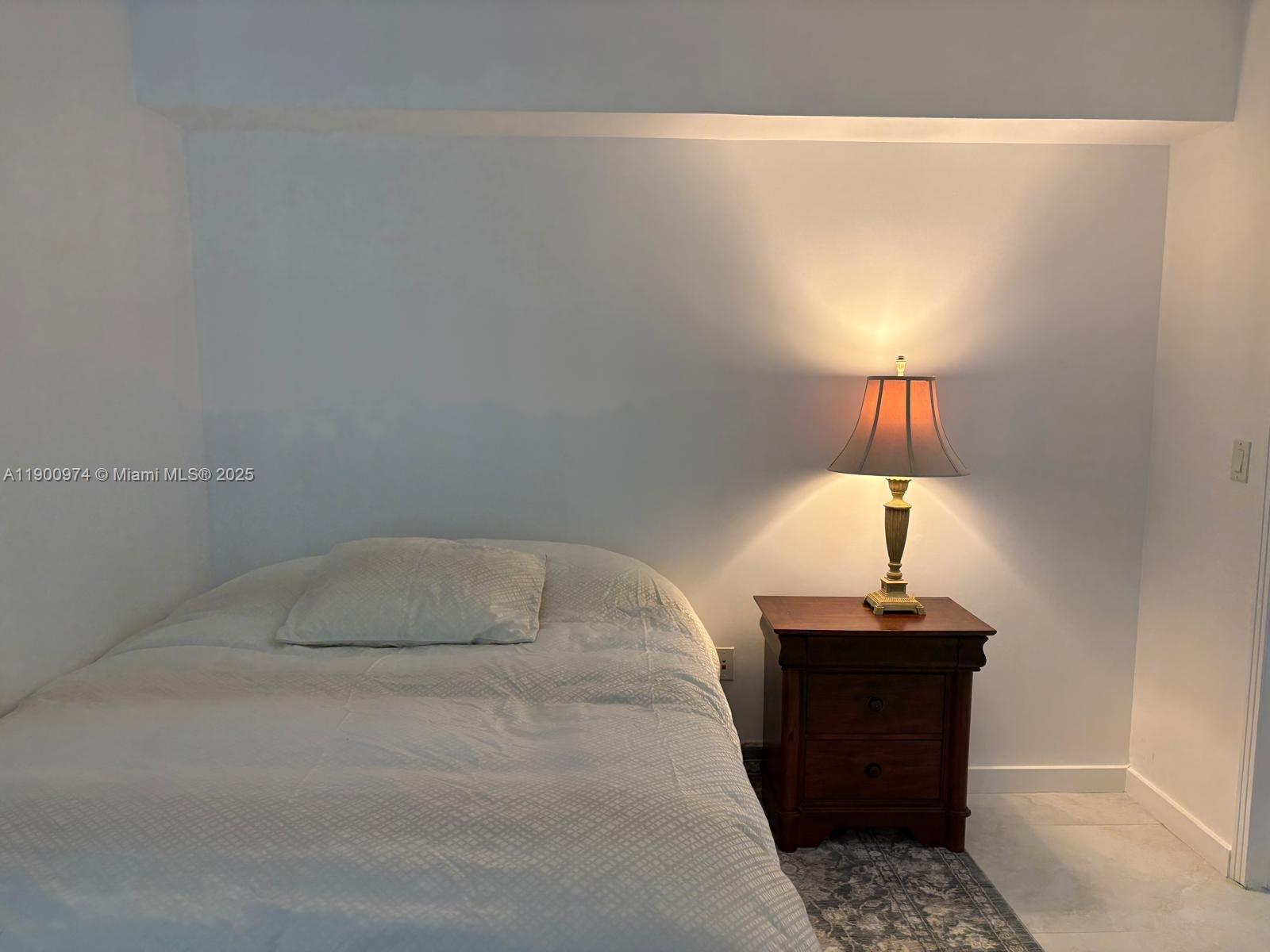 9055 Southwest 73rd Court, Unit 1806 Miami, FL 33156 - Photo 12 of 23 a bathroom with a sink and a lamp