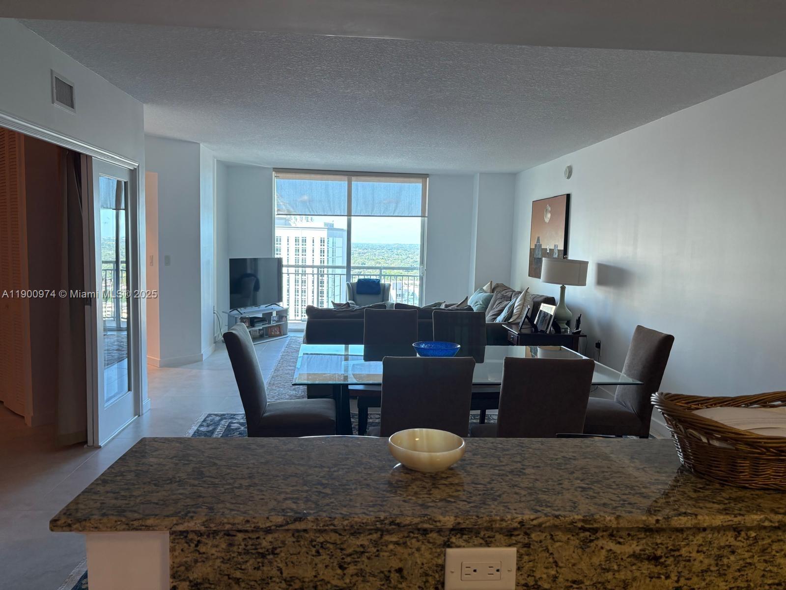 9055 Southwest 73rd Court, Unit 1806 Miami, FL 33156 - Photo 5 of 23 a living room with furniture wooden floor and a window