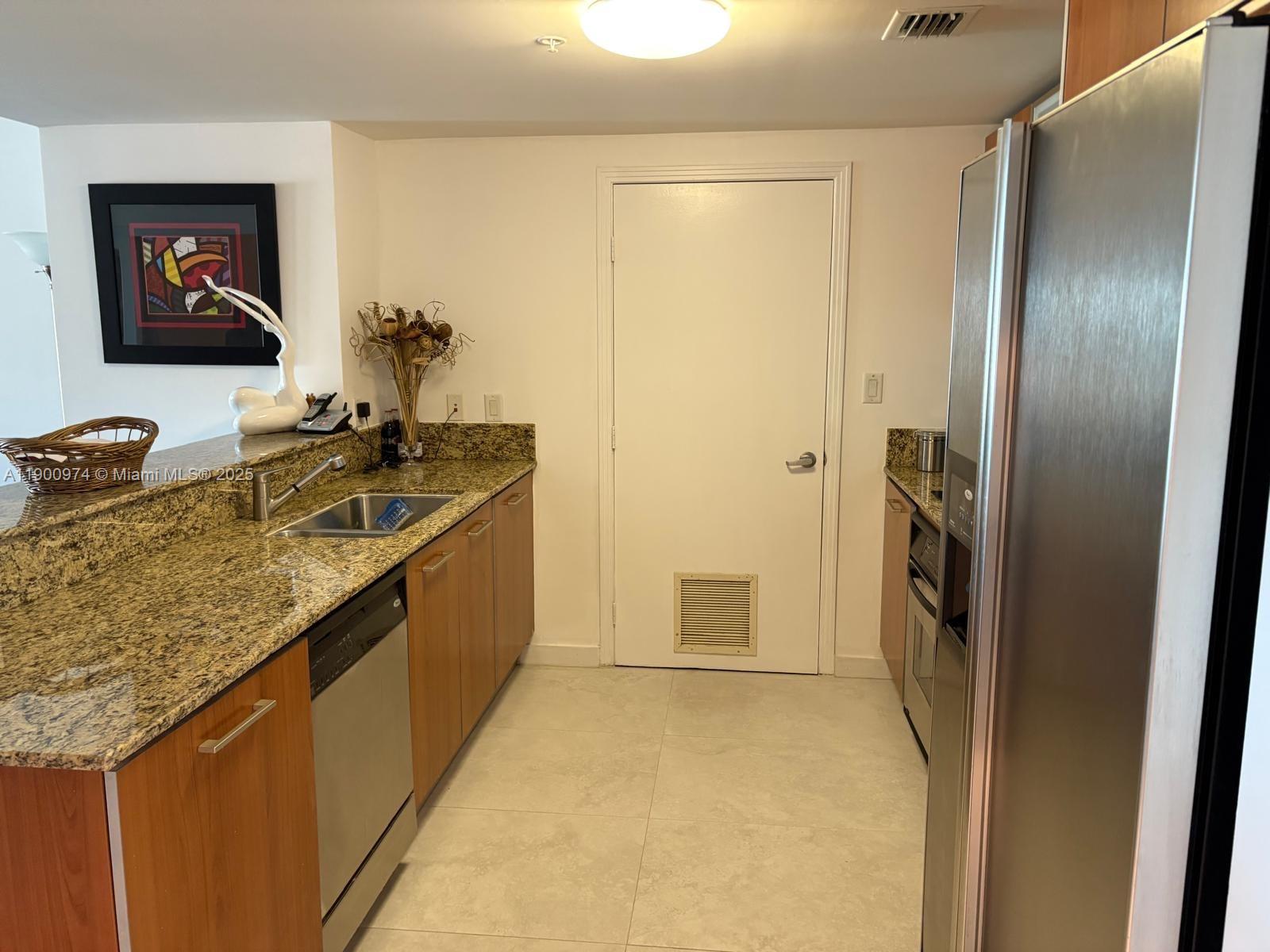 9055 Southwest 73rd Court, Unit 1806 Miami, FL 33156 - Photo 9 of 23 a bathroom with a granite countertop sink and a mirror