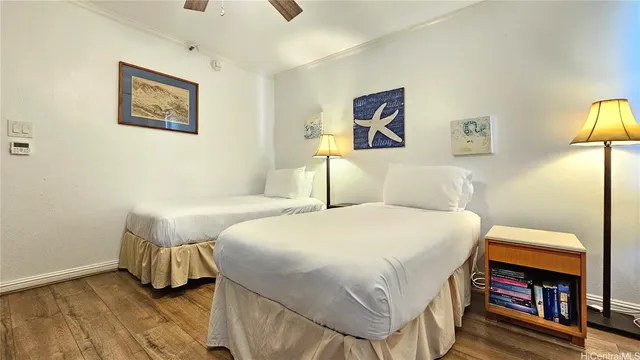 a bedroom with a bed and a painting on the wall