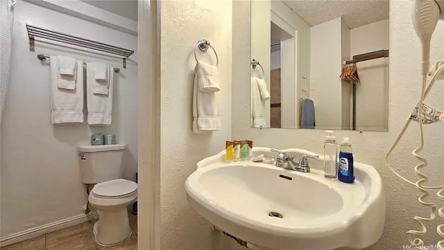 a bathroom with a sink a toilet and a mirror