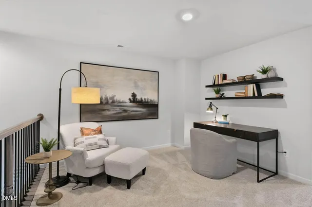 a living room with furniture and a painting on the wall