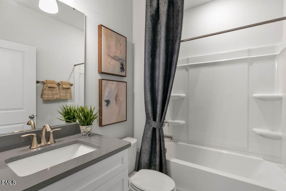 Undisclosed Address Fuquay-Varina, NC 27526 - Photo 19 of 28 a bathroom with a granite countertop sink toilet and shower