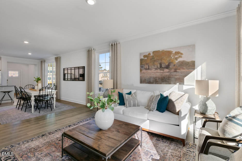 Undisclosed Address Fuquay-Varina, NC 27526 - Photo 8 of 28 a living room with furniture and wooden floor