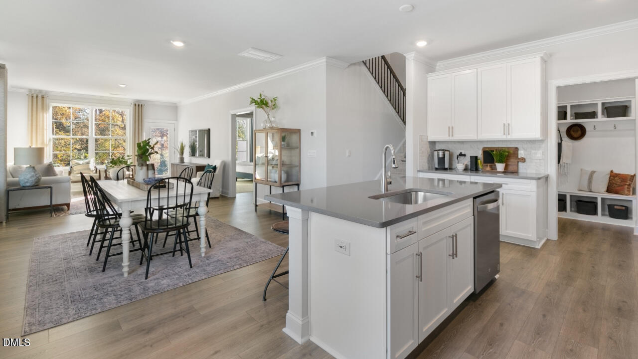 Undisclosed Address Fuquay-Varina, NC 27526 - Photo 10 of 28 a kitchen with stainless steel appliances granite countertop a table chairs sink and cabinets
