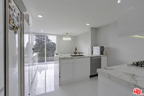a kitchen with stainless steel appliances granite countertop a sink and cabinets