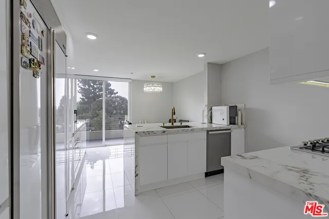 a kitchen with stainless steel appliances granite countertop a sink and cabinets