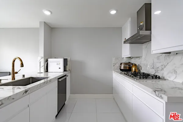 a kitchen with a refrigerator and cabinets