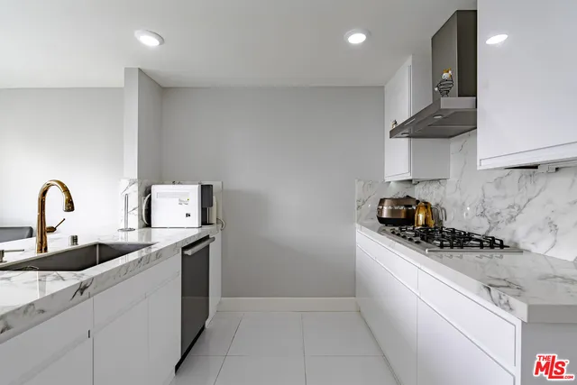 a kitchen with a refrigerator and cabinets