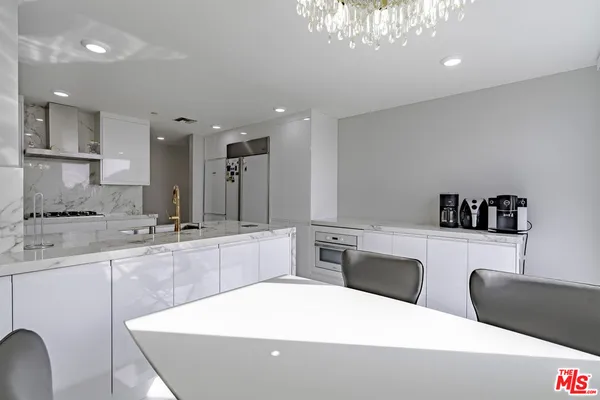 a kitchen with a refrigerator and a sink