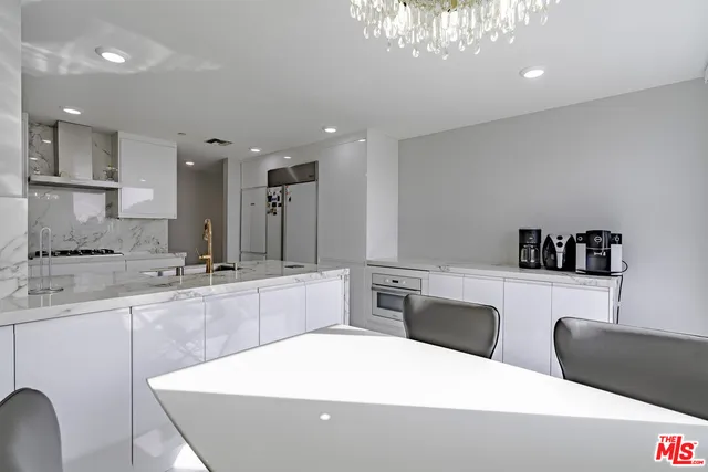 a kitchen with a refrigerator and a sink