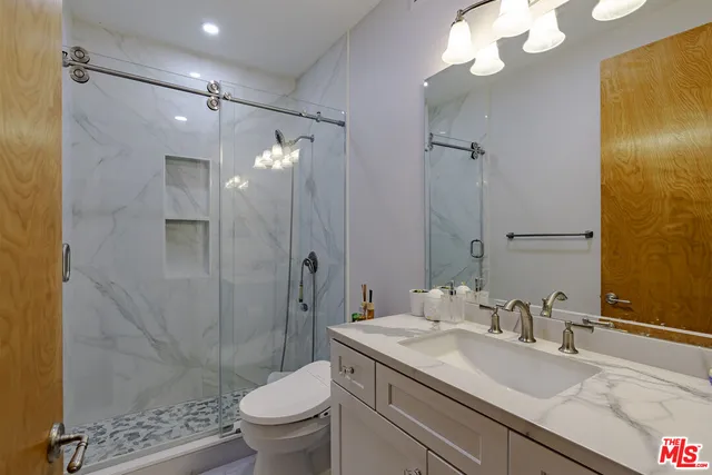 a spacious bedroom with a bed and a couch