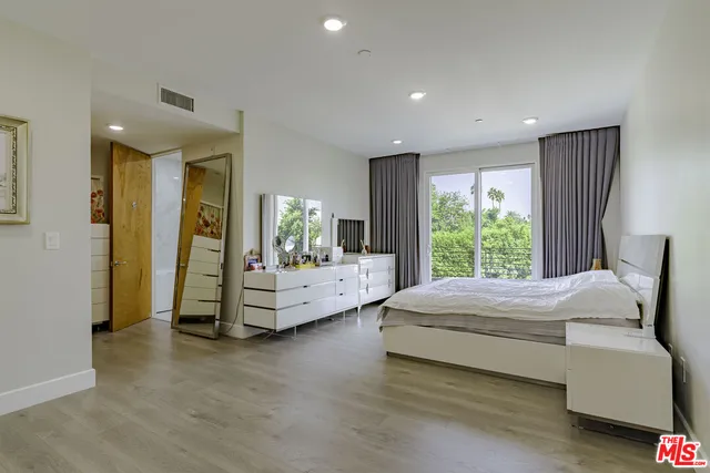 a bedroom with a bed and a couch