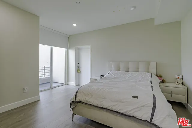 a spacious bedroom with a bed and a couch