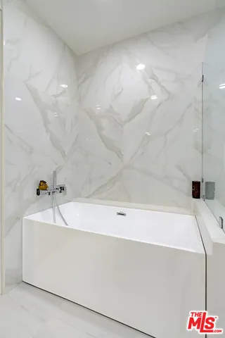 a view of a livingroom with furniture and staircase