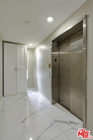 a bathroom with a shower and a glass door