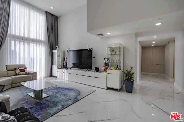 a bathroom with a granite countertop sink a toilet and shower