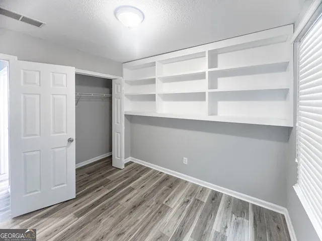 a view of a room with wooden floor and closet