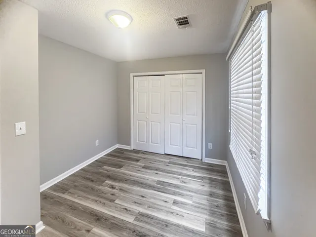 a view of a room with wooden floor and stairs