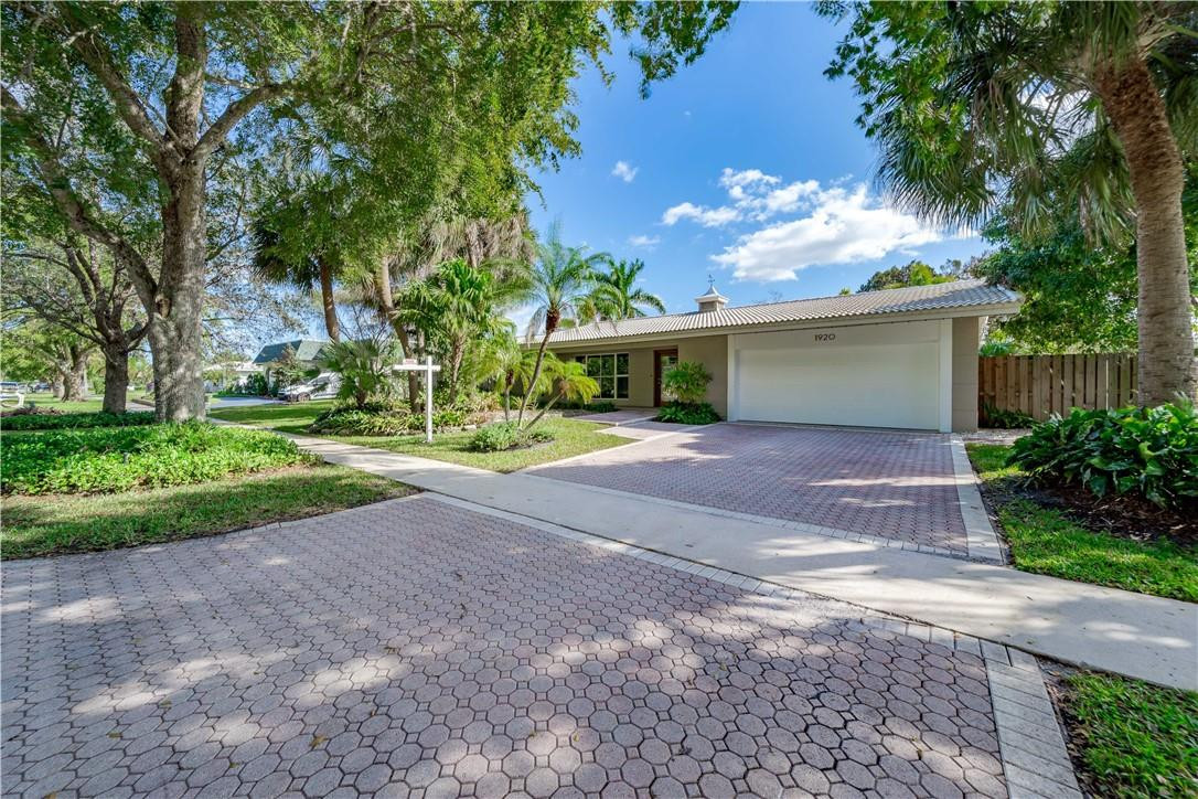 1920 Southwest 67th Terrace Plantation, FL 33317 - Photo 1 of 65 a front view of a house with a yard and a garage