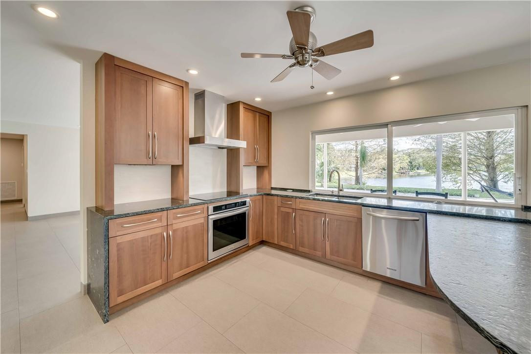 1920 Southwest 67th Terrace Plantation, FL 33317 - Photo 19 of 65 a large kitchen with stainless steel appliances granite countertop a stove sink and refrigerator