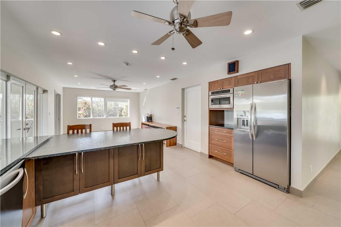 1920 Southwest 67th Terrace Plantation, FL 33317 - Photo 20 of 65 a kitchen with stainless steel appliances granite countertop a refrigerator and a sink