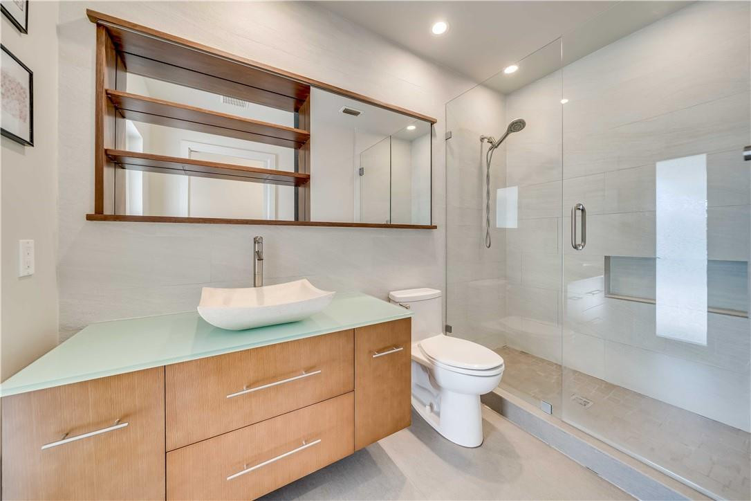 1920 Southwest 67th Terrace Plantation, FL 33317 - Photo 29 of 65 a bathroom with a granite countertop sink toilet and shower