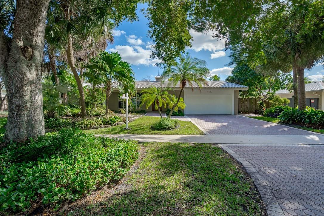 1920 Southwest 67th Terrace Plantation, FL 33317 - Photo 3 of 65 a view of a house with a yard and large trees