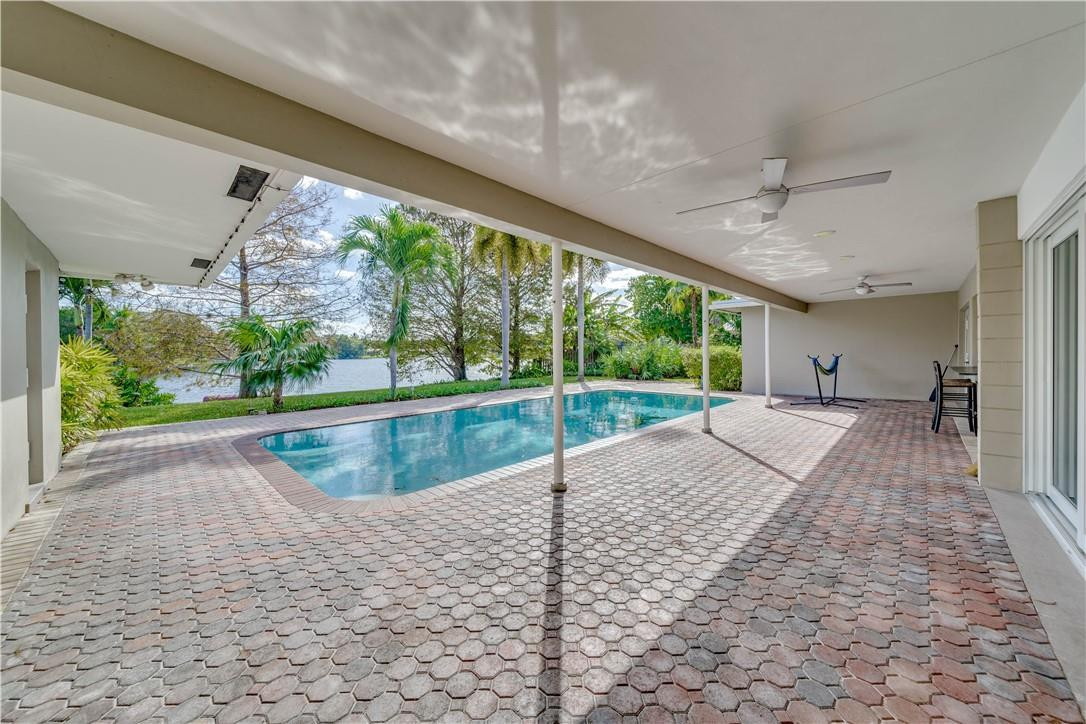1920 Southwest 67th Terrace Plantation, FL 33317 - Photo 43 of 65 a view of swimming pool with a yard and outdoor seating