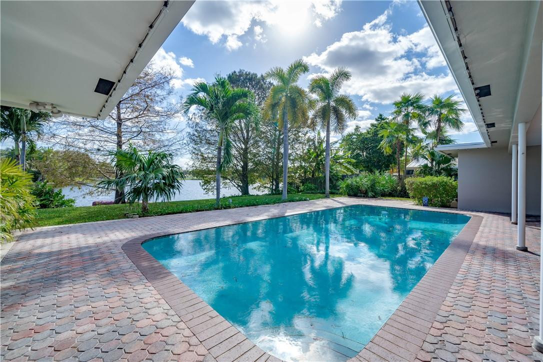 1920 Southwest 67th Terrace Plantation, FL 33317 - Photo 44 of 65 a view of a swimming pool with a yard