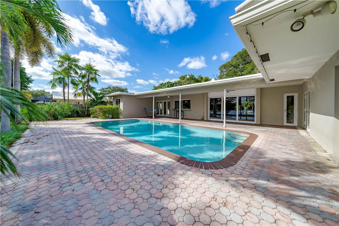 1920 Southwest 67th Terrace Plantation, FL 33317 - Photo 48 of 65 a view of a house with a backyard and a patio