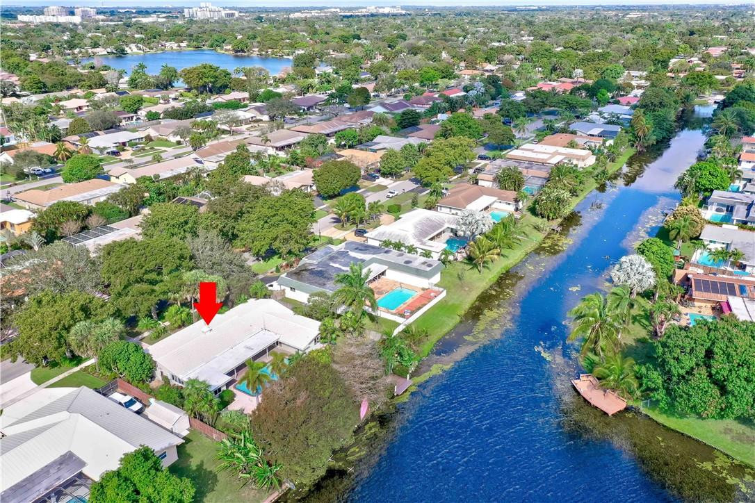 1920 Southwest 67th Terrace Plantation, FL 33317 - Photo 60 of 65 an aerial view of a house with a yard and lake view in back