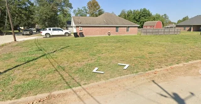 a front view of house with yard and car parked