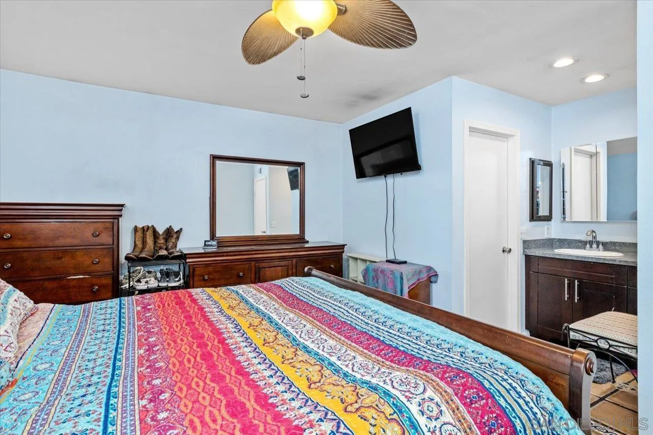 2337 Fallingleaf Road Oceanside, CA 92056 - Photo 17 of 34 a bedroom with a bed and flat screen tv