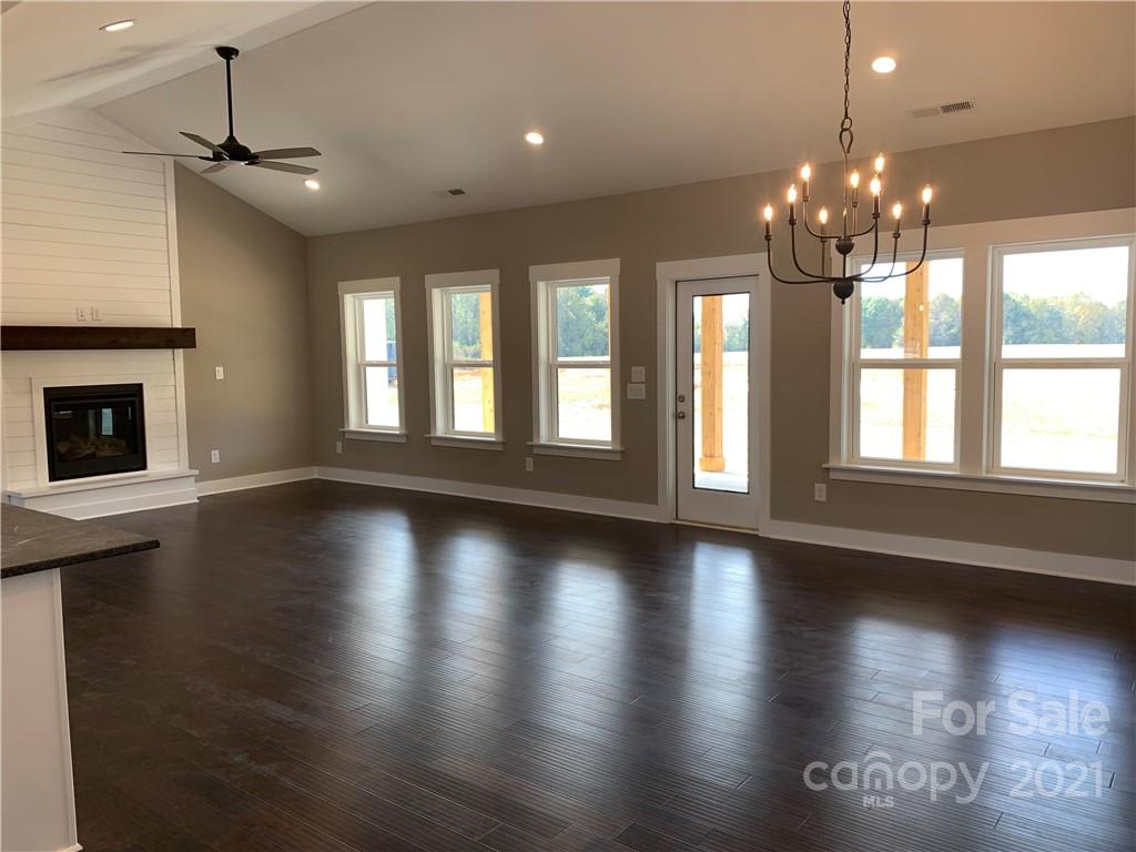 470 Cal Kennedy Road Cleveland, NC 27013 - Photo 3 of 21 an empty room with wooden floor and large windows