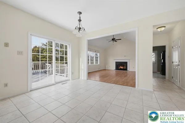 a view of an empty room with a fireplace and a window