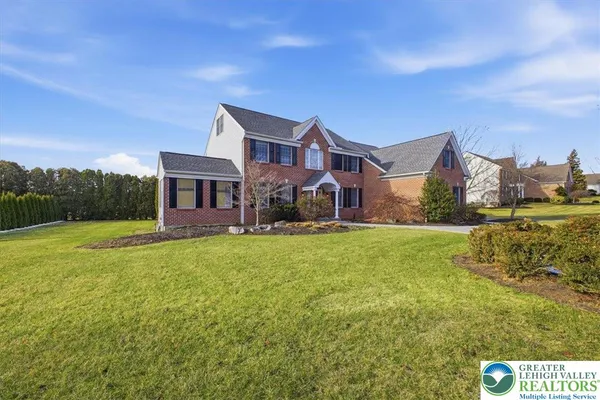 a front view of house with yard and green space