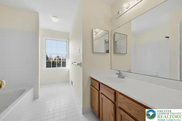 a bathroom with a sink a mirror and bathtub