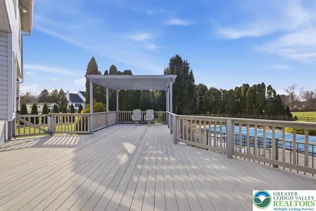 a view of a balcony with wooden floor and iron stairs