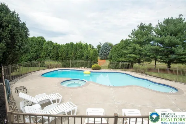 a view of a swimming pool with a yard