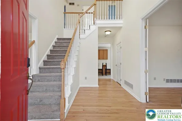 a view of a hallway with wooden floor and entryway