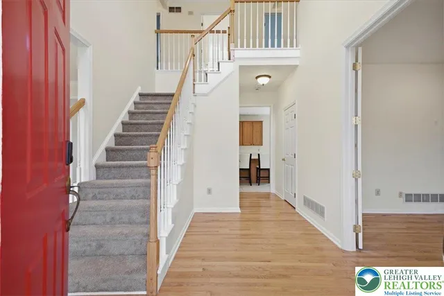a view of a hallway with wooden floor and entryway