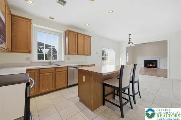a kitchen with a table chairs sink and cabinets