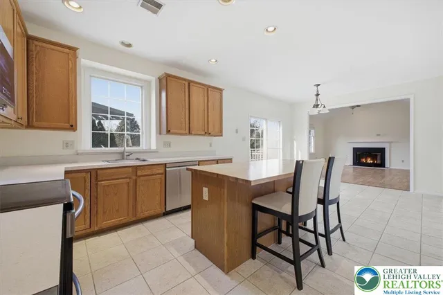 a kitchen with a table chairs sink and cabinets