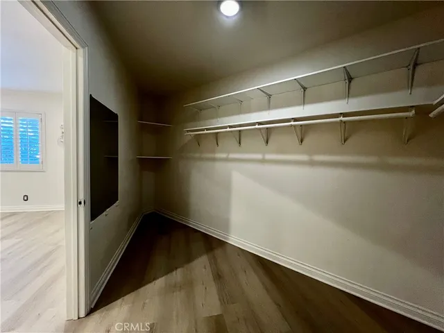 a view of storage and utility room with wooden floor