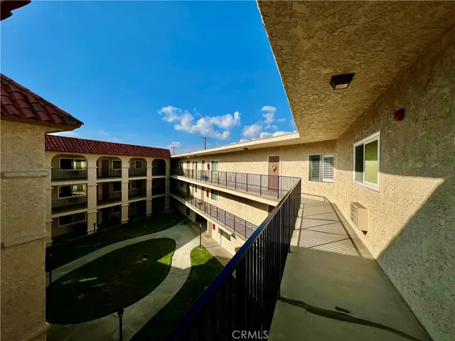 a view of a house with backyard and wooden fence
