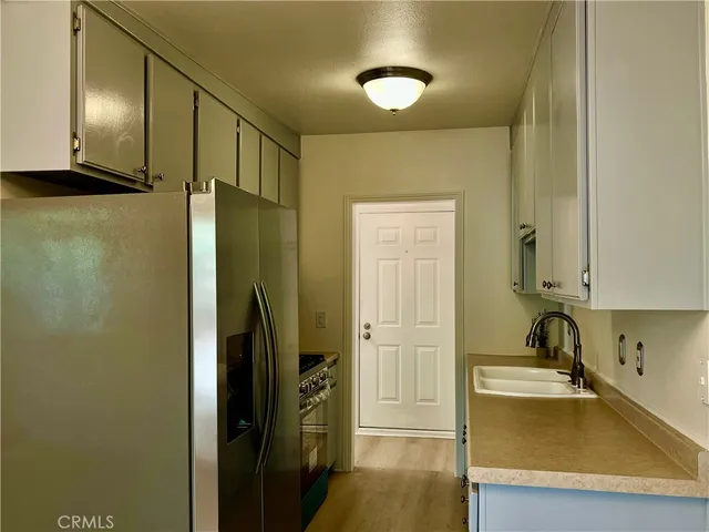 a stove top oven sitting inside of a kitchen