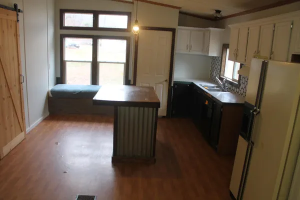a view of kitchen and hallway with windows